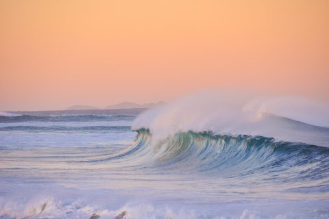 Ocean wave at sunset
