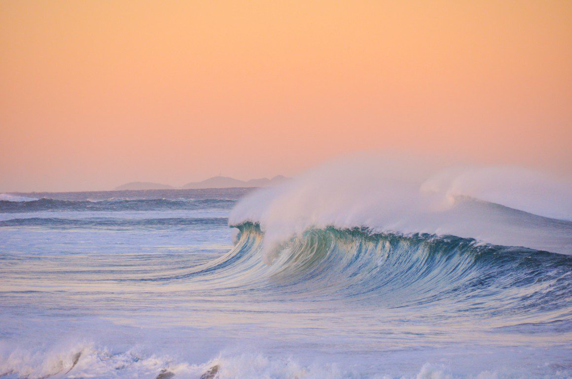 Ocean wave at sunset