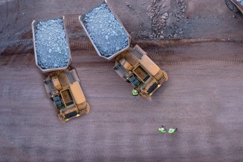 Aerial view of mining trucks at a mine site in Australia