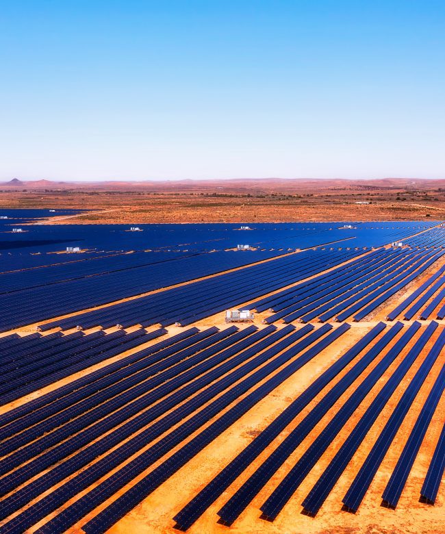 Broken hill solar farm on endless plains of red soil outback of Australia - aerial industrial landscape.