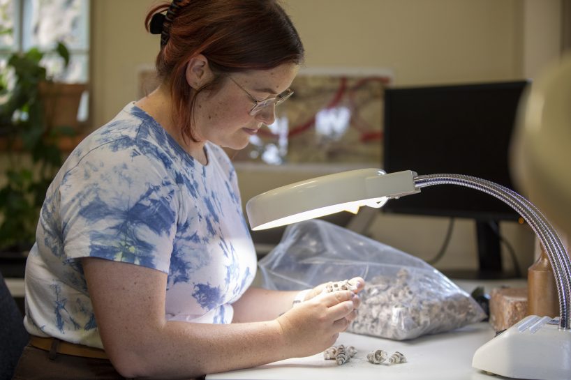 Female Archaeologist assessing artefacts