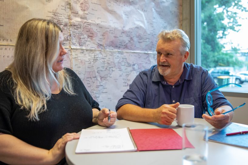 Female and Male discussing Environmental and Social Consulting outcomes