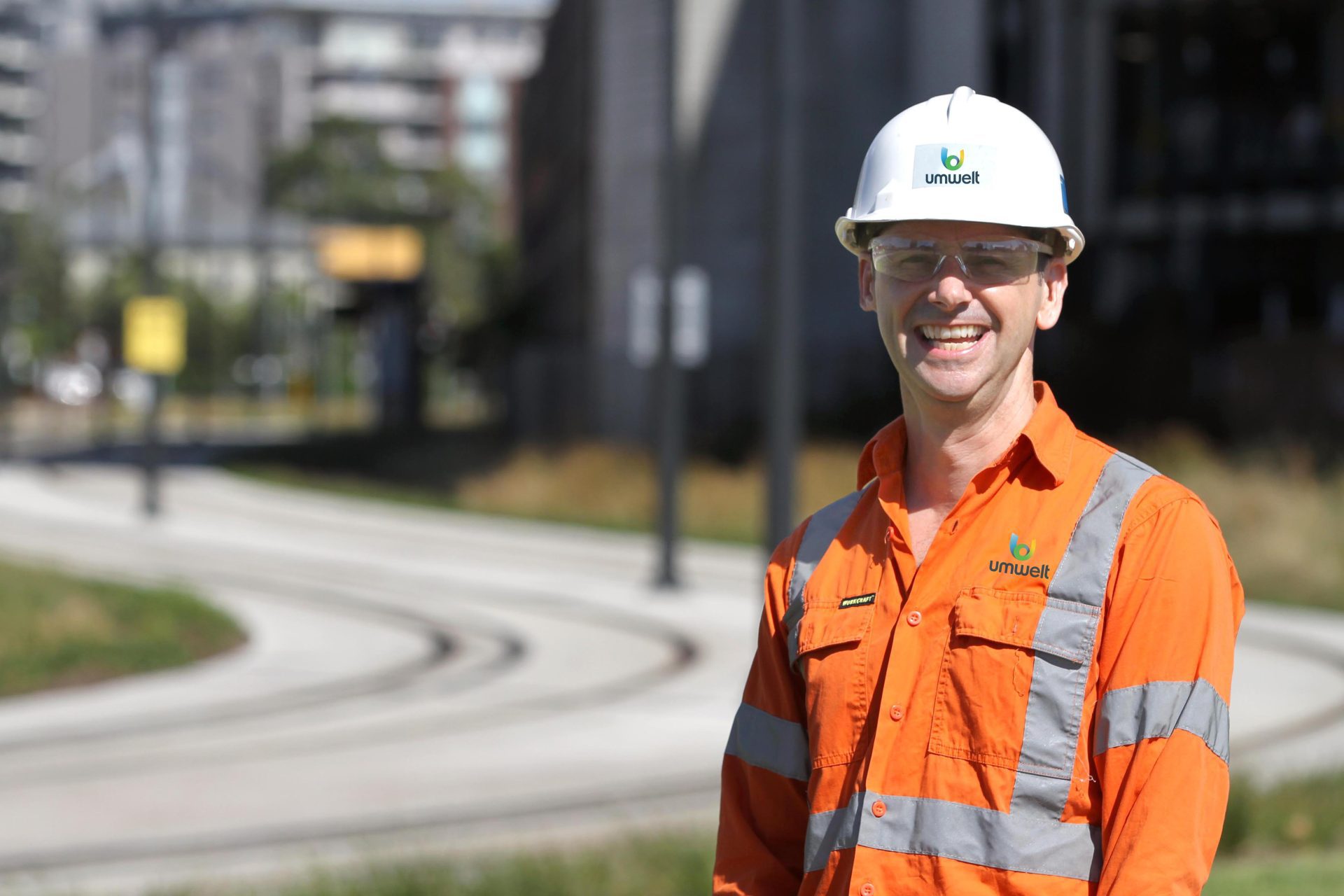 Male in front of Newcastle Light Rail in safety gear